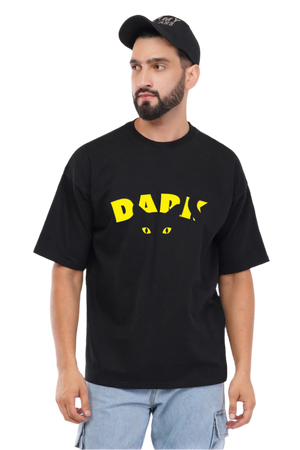 Man wearing a black t-shirt with yellow text and a cat graphic on a white background